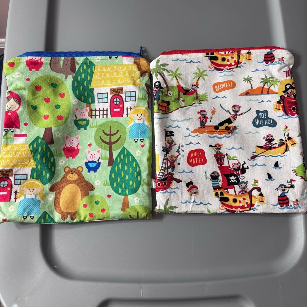 New with out tags.  Lot of two zipper pouches pirate and farm storybook scenes